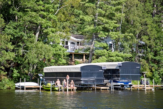 Wide view of ShoreStation dock, boat lifts and canopies